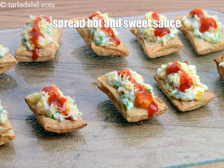 Step 18 – Spread &frac12; tsp &nbsp;<a href="https://www.tarladalal.com/glossary-hot-and-sweet-chilli-sauce-1600i">hot and sweet sauce</a>&nbsp;evenly over it.