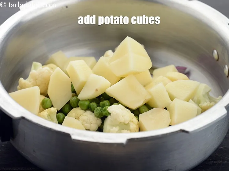 Step 23 – Add 3/4 cup&nbsp;<a href="https://www.tarladalal.com/glossary-potato-cubes-725i">potato cubes</a>.