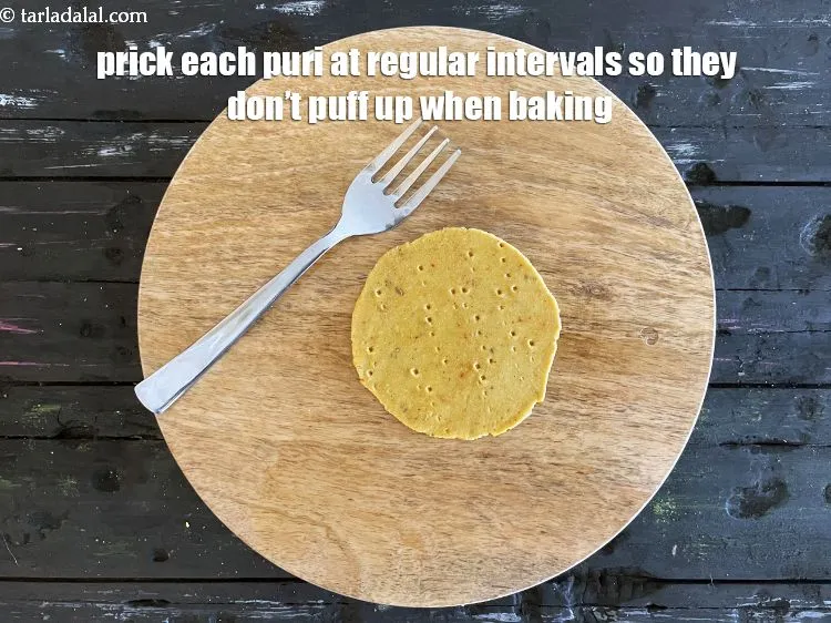 Step 19 – Prick each puri evenly with a fork at regular intervals.&nbsp;<meta charset="UTF-8" />Pricking ensures that the …