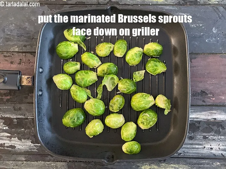 Step 18 – <meta charset="UTF-8" /> Put the marinated brussel sprouts halves face down on the griller. &nbsp;