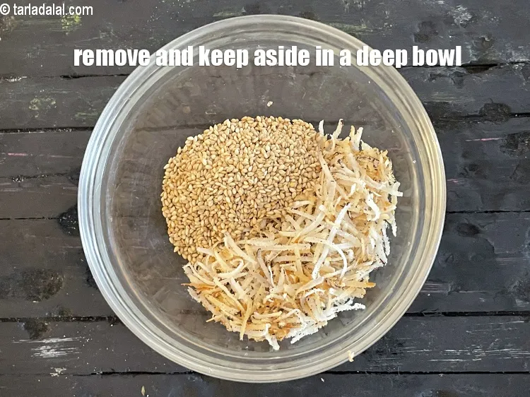 Step 18 – Remove it in the bowl containing roasted dry coconut and keep aside.