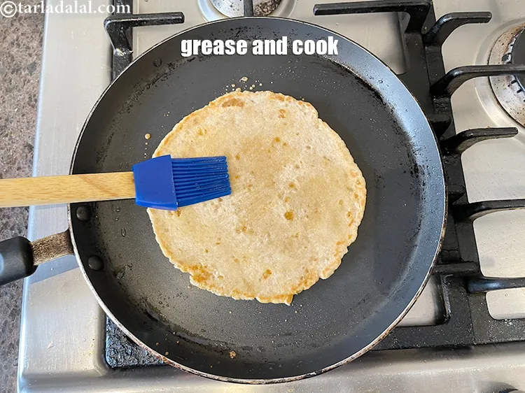 Step 19 – <meta charset="UTF-8" /> Now brush some ghee on the cooked surface top ( as we …