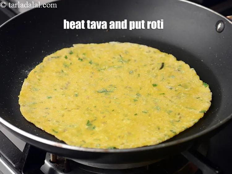 Step 16 – Heat a non-stick tava (griddle). Place the roti on it.&nbsp;