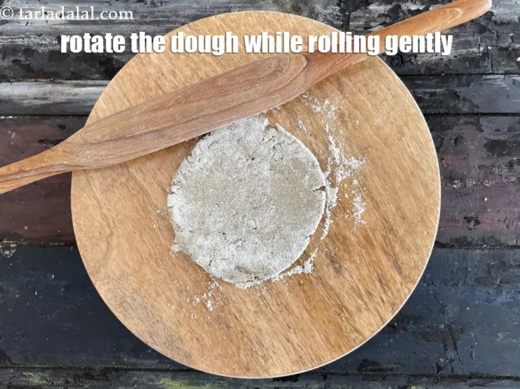 Step 33 – Rotate the dough while rolling and use bajra atta to prevent any sticking to the …