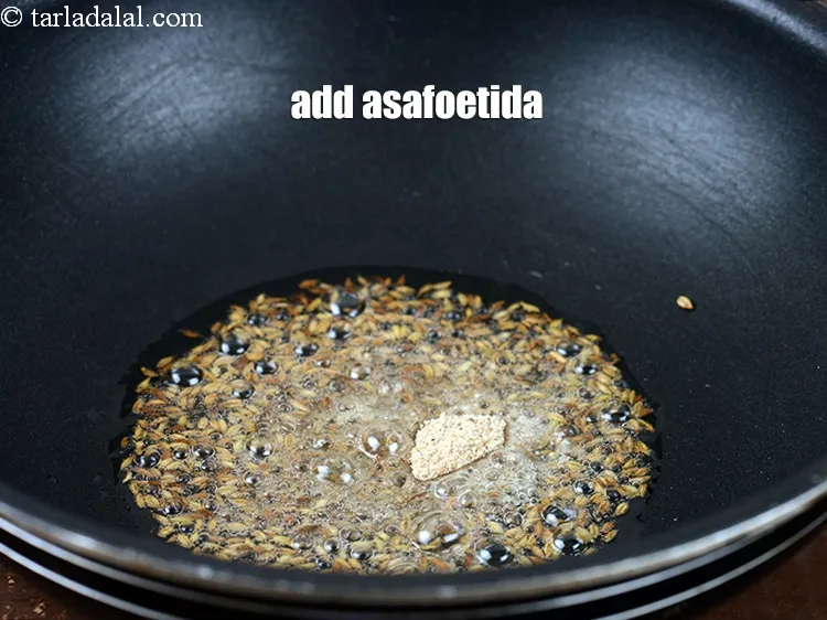 Step 18 – Add &frac14; tsp <a href="https://www.tarladalal.com/glossary-asafoetida-hing-113i">asafoetida (hing)</a>.