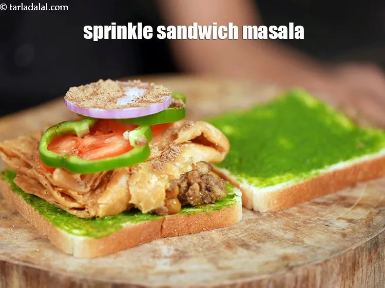 Step 20 – Finally sprinkle &frac14; tsp of <a href="https://www.tarladalal.com/glossary-sandwich-masala-1456i">sandwich masala</a> over it.&nbsp;