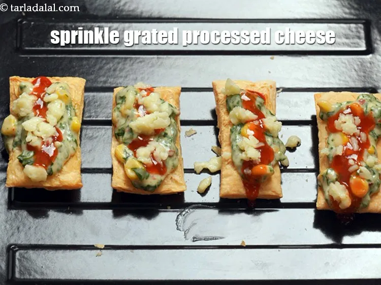 Step 18 – Sprinkle 1 tsp&nbsp;<a href="https://www.tarladalal.com/glossary-grated-processed-cheese-868i">grated processed cheese</a>&nbsp;over it and evenly over it.
