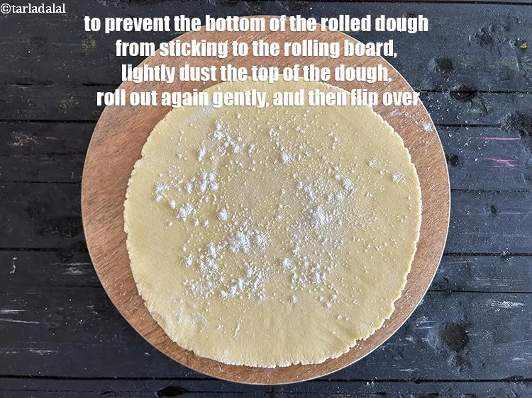 Step 18 – To prevent the bottom of the rolled dough from sticking to the rolling board, lightly …