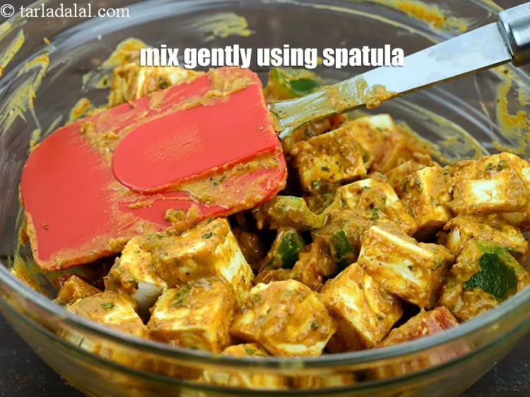 Step 38 – Coat&nbsp;the paneer pieces in the marination gently using a spatula so that the paneer pieces …