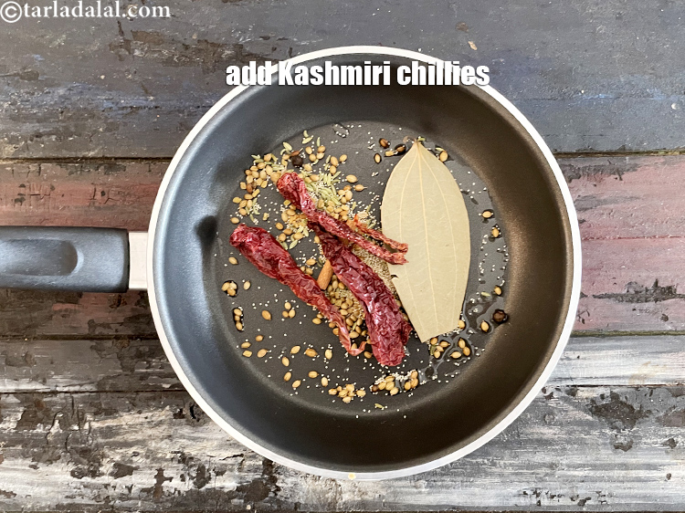 Step 19 – Add&nbsp;<meta charset="UTF-8" />3&nbsp;<a href="glossary-whole-dry-kashmiri-red-chillies-kashmiri-mirch-kashmiri-lal-mirch-332i">whole dry red kashmiri chillies</a>&nbsp;, broken into pieces.