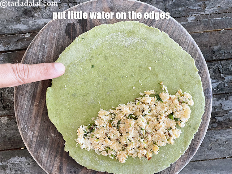 Step 44 – Put little water with your finger on the edges of paratha to enable it to …