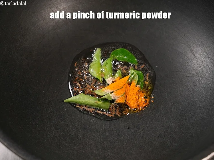 Step 19 – Add a pinch of <a href="https://www.tarladalal.com/glossary-turmeric-powder-haldi-645i">turmeric powder (haldi)</a>.