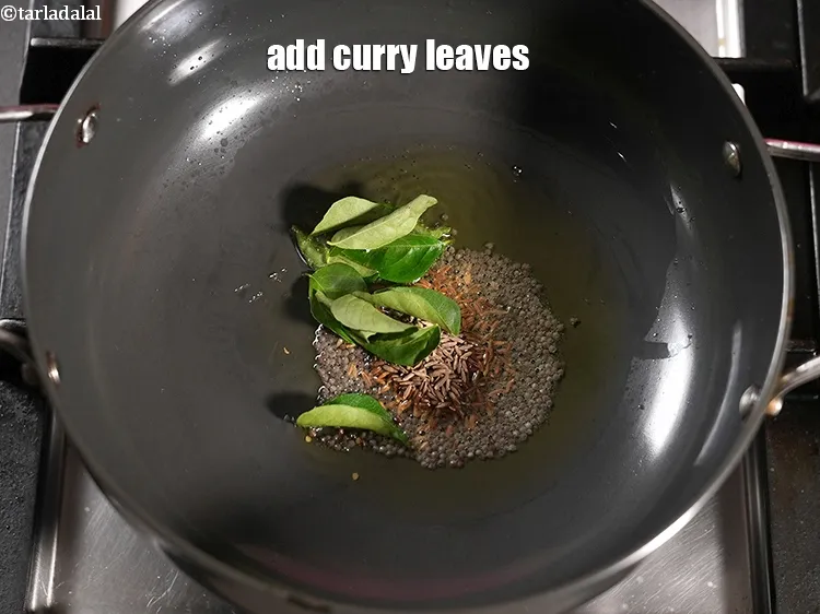 Step 19 – Add 10 <a href="https://www.tarladalal.com/glossary-curry-leaves-kadi-patta-kadipatta-388i">curry leaves (kadi patta)</a>.
