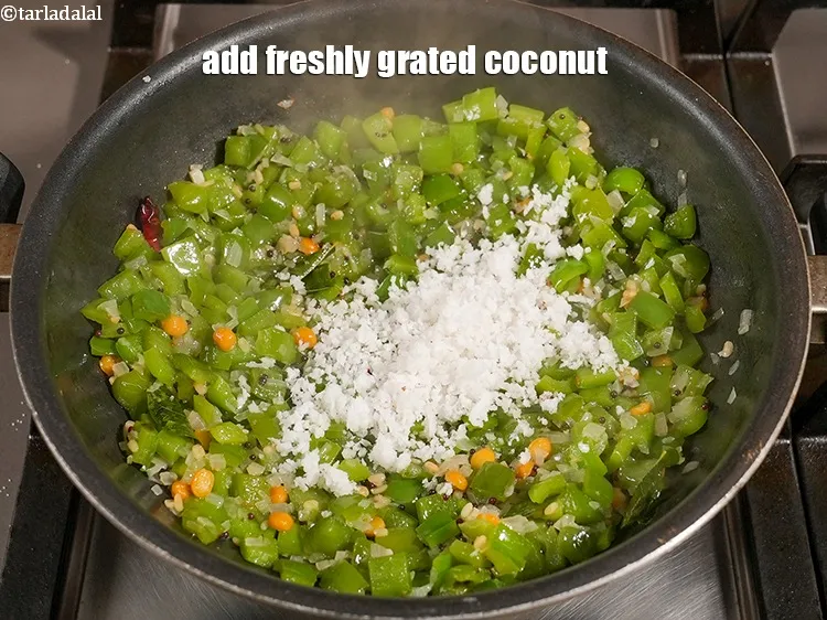 Step 19 – Add &frac14; cup freshly <a href="https://www.tarladalal.com/glossary-grated-coconut-852i">grated coconut</a>.