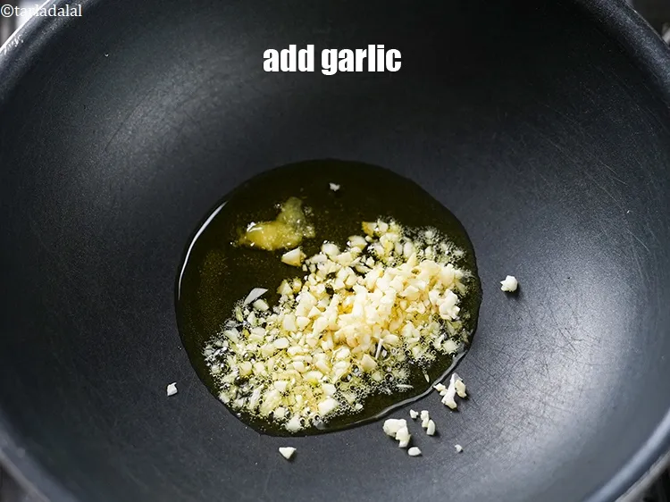 Step 19 – Add 1 tbsp finely <a href="https://www.tarladalal.com/glossary-chopped-garlic-790i">chopped garlic (lehsun)</a>.
