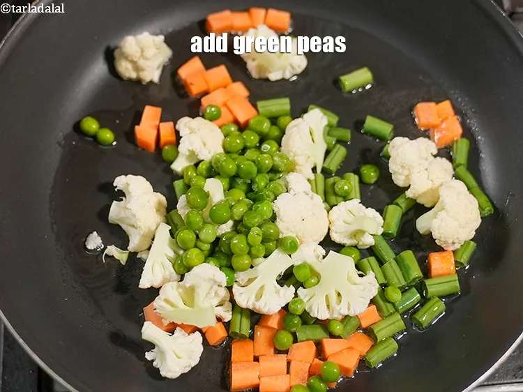 Step 19 – Add &frac14; cup <a href="https://www.tarladalal.com/glossary-green-peas-matar-hare-matar-vatana-180i">green peas</a>.&nbsp;