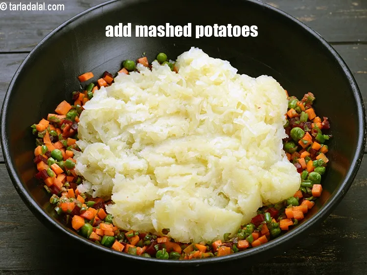 Step 20 – Add 3 cups <a href="https://www.tarladalal.com/glossary-boiled-and-mashed-potatoes-1831i">mashed potatoes</a>.
