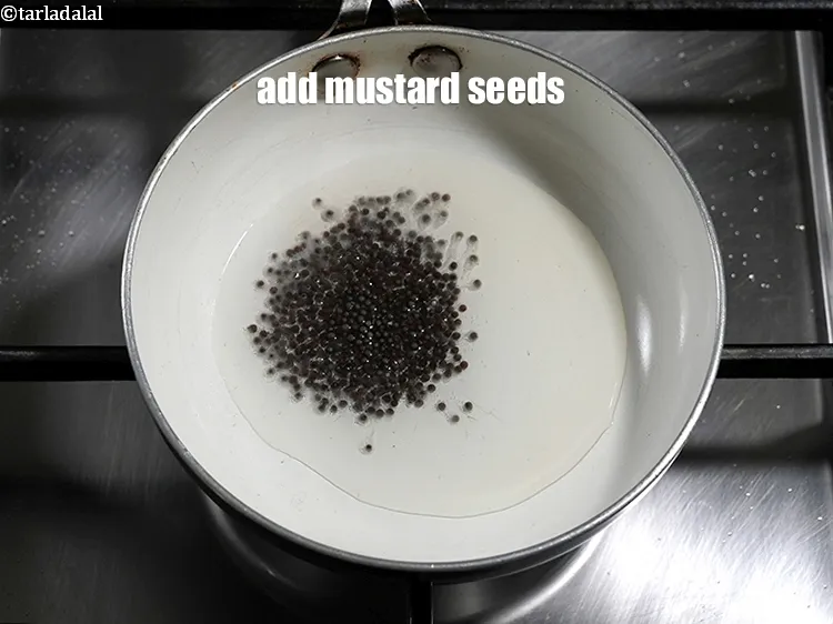 Step 21 – Add &frac12; tsp <a href="https://www.tarladalal.com/glossary-mustard-seeds-sarson-rai-sarson-ke-beej-525i">mustard seeds ( rai / sarson)</a>.