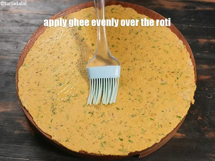 Step 19 – Apply &frac14; tsp ghee evenly over the roti.