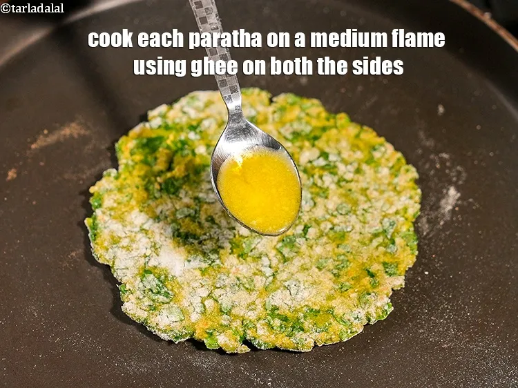 Step 19 – Cook each paratha on a medium flame using &frac14; tsp ghee&nbsp;on both the sides.