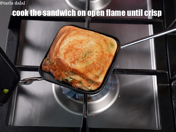Step 19 – Cook the sandwich on low open flame until its golden brown and crisp.