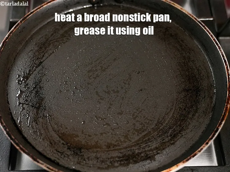 Step 22 – Heat a broad nonstick pan, grease it using 1 tsp oil.