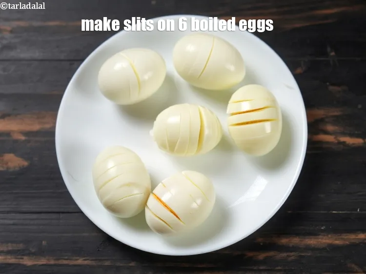 Step 19 – To make <strong>egg chettinad curry</strong>, make slits on 6&nbsp;<a href="https://www.tarladalal.com/glossary-boiled-eggs-2369i">boiled eggs</a> and keep aside.