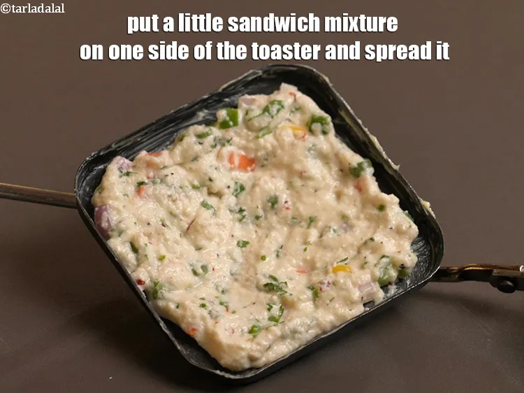 Step 19 – Put a little sandwich mixture on one side of the toaster and spread it.