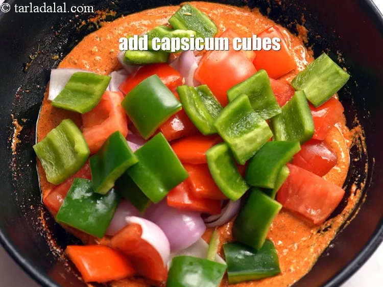 Step 19 – Add 3/4 cup <a href="https://www.tarladalal.com/glossary-capsicum-cubes-170i">capsicum cubes</a>.