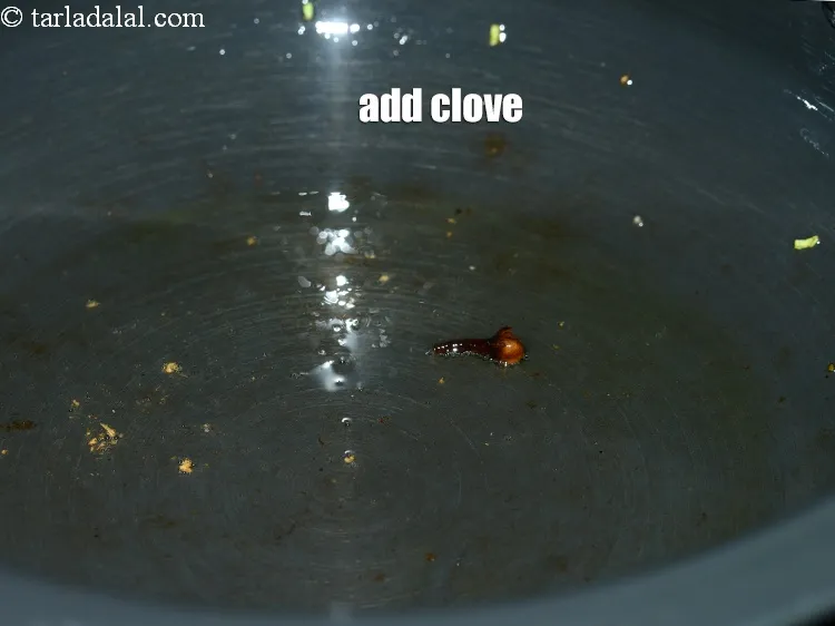 Step 20 – Add 1 <a href="https://www.tarladalal.com/glossary-cloves-laung-lavang-322i">clove (laung / lavang)</a>.