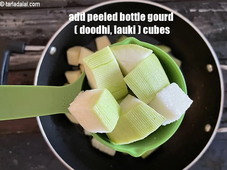 Step 20 – Add&nbsp;<meta charset="UTF-8" />1/2 cup&nbsp;peeled&nbsp;<a href="glossary-bottle-gourd-cubes-1336i">bottle gourd (doodhi / lauki) cubes</a>.