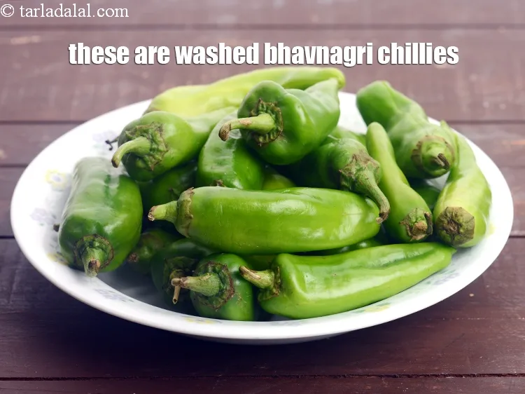Step 21 – These are bhavnagri chillies. Wash them with clean water. wehave taken&nbsp;20&nbsp;<a href="https://tarladalal.com/glossary-bhavnagri-chillies-bhavnagri-mirchi-337i">bhavanagari chillies</a>.&nbsp;