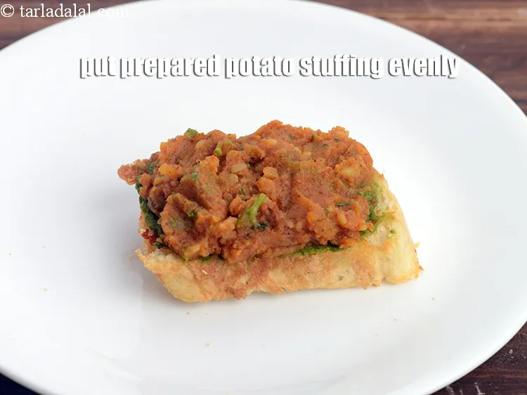 Step 18 – Put 1 tbsp of the prepared potato stuffing evenly over it.