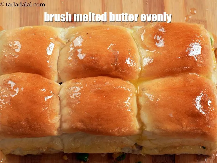 Step 20 – Brush <a href="https://www.tarladalal.com/glossary-melted-butter-1941i">melted butter</a> evenly over each side.&nbsp;
