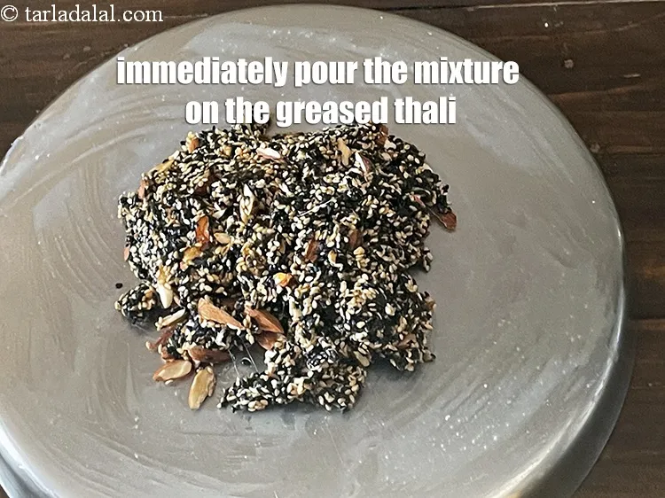 Step 25 – Immediately pour the entire mixture over the greased thali or a smooth stone surface. If …