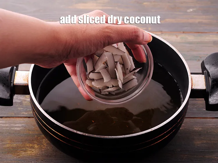 Step 21 – In the same hot oil, add the <a href="https://www.tarladalal.com/glossary-dry-coconut-kopra-270i#ing_2273" target="_blank">sliced dry coconut</a>.