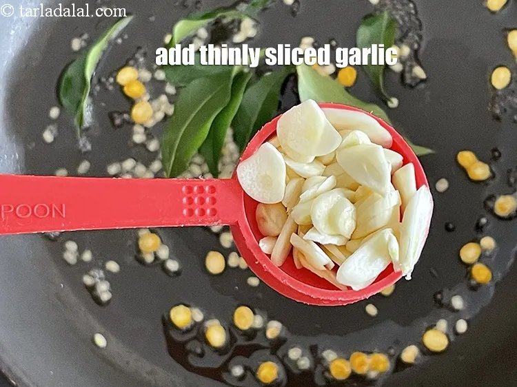 Step 19 – Add&nbsp;<meta charset="UTF-8" />1 tbsp&nbsp;thinly&nbsp;<a href="glossary-sliced-garlic-773i">sliced garlic (lehsun)</a>.