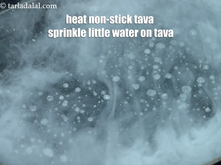 Step 19 – Heat a non-stick tava (griddle) sprinkle a little water on the tava (griddle).