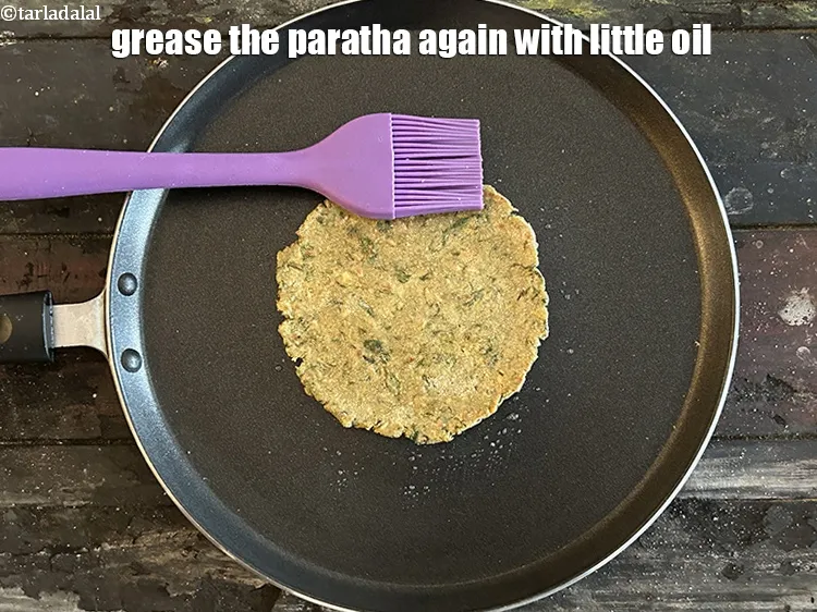 Step 20 – Grease the top of the paratha again with oil using a brush.