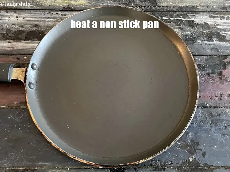Step 20 – <meta charset="UTF-8" />Heat a non-stick tava (griddle).