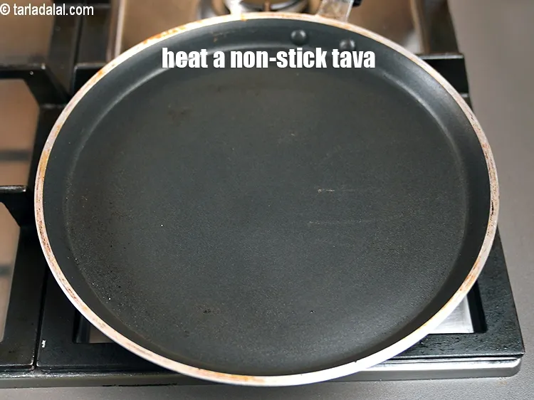 Step 22 – <meta charset="UTF-8" />Heat a non-stick tava (griddle).&nbsp;