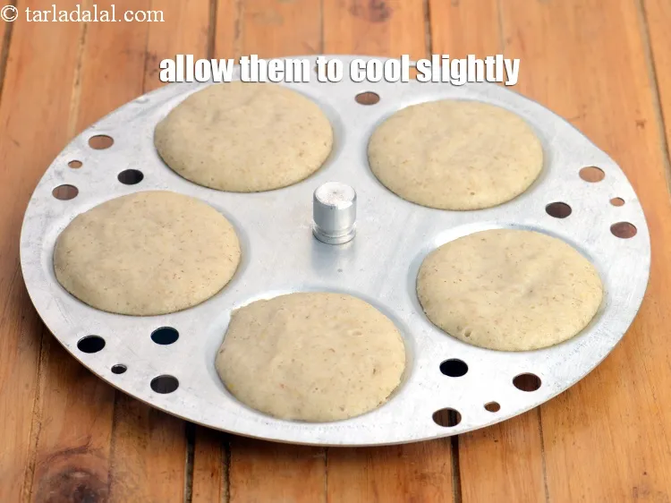 Step 19 – Remove the idli moulds from the steamer and allow them to cool slightly.&nbsp;