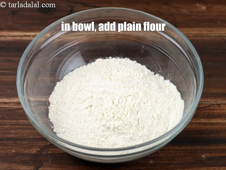 Step 21 – In a deep bowl, add 1&frac12; cups <a href="https://www.tarladalal.com/glossary-plain-flour-maida-188i">plain flour (maida)</a>.