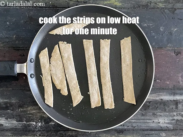 Step 20 – Cook the 8 strips&nbsp;on the hot tava (griddle) on low heat for one minute.