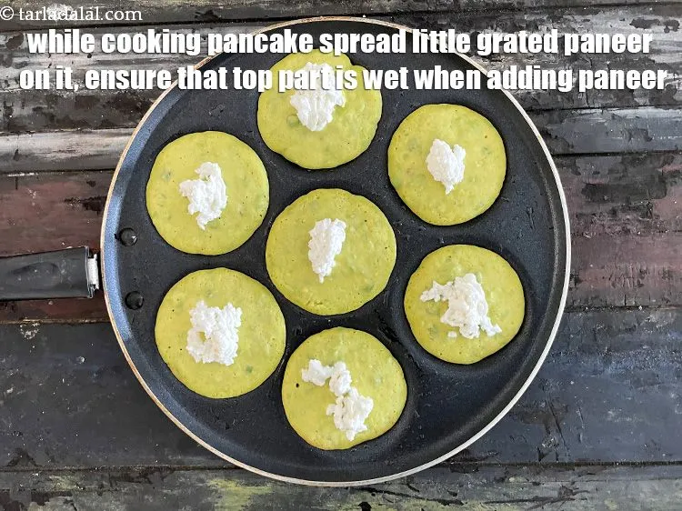 Step 19 – While cooking pancake, sprinkle little grated paneer over it.