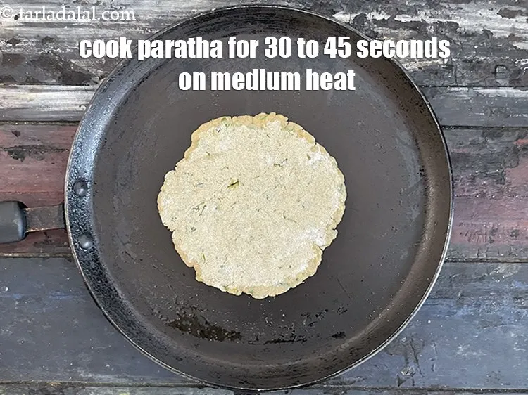 Step 21 – <meta charset="UTF-8" />Cook paratha for 30 to 45 seconds on a medium flame.&nbsp;&nbsp;<br /> &nbsp;