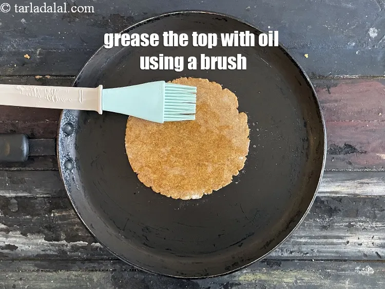 Step 21 – Grease the paratha with oil.