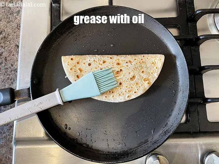 Step 41 – Then grease the top of the stuffed paratha.