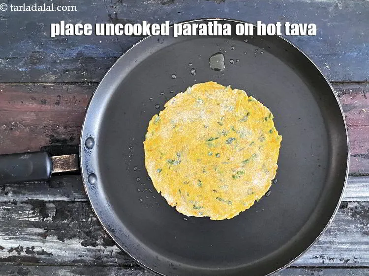 Step 19 – Place uncooked paratha on non stick pan.