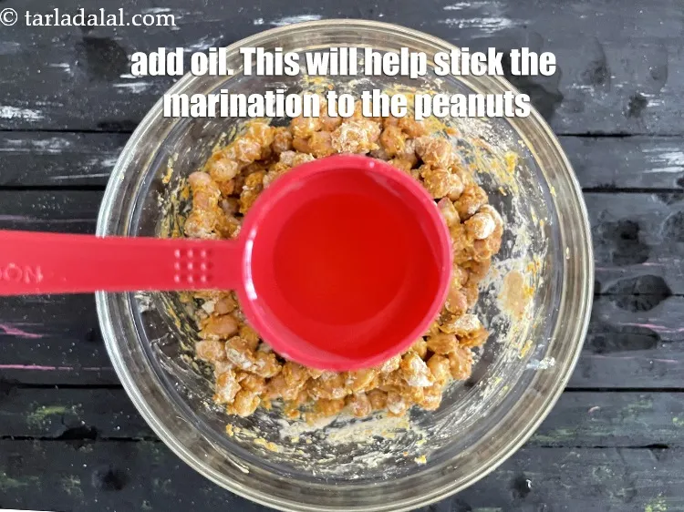 Step 20 – Add 1 tablespoon oil. <u><em>This will help stick the marination to the peanuts.</em></u>